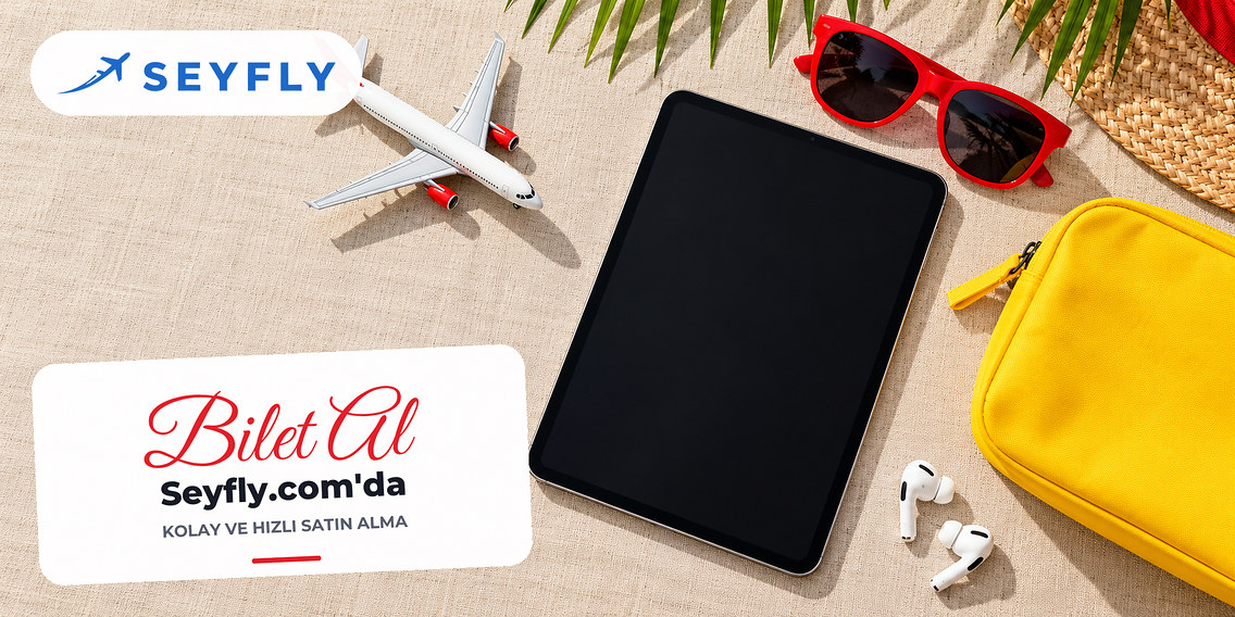 Tablet, uçak maketi ve seyahat aksesuarları masa üstünde