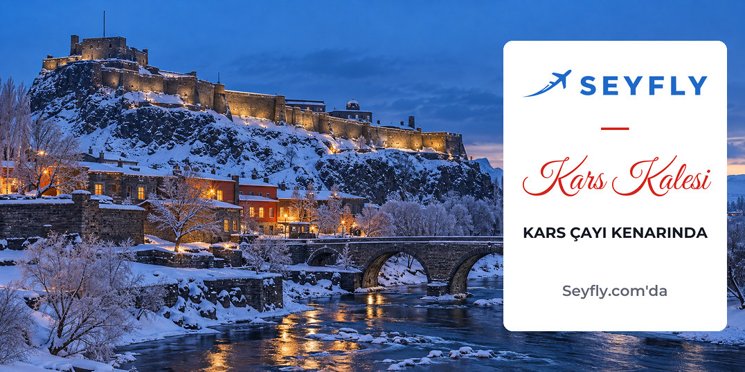Karla kaplı Kars Kalesi ve eteğinden akan Kars Çayı üzerinde taş köprü